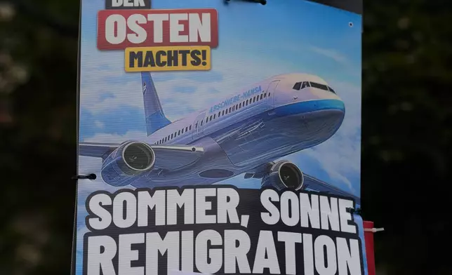 An AfD election campaign posters showing the slogan "summer, sun, remigration," and the photo of a plane dubbed "deportation airline" is displayed in Erfurt, Germany, Wednesday, Aug. 14, 2024. (AP Photo/Markus Schreiber)