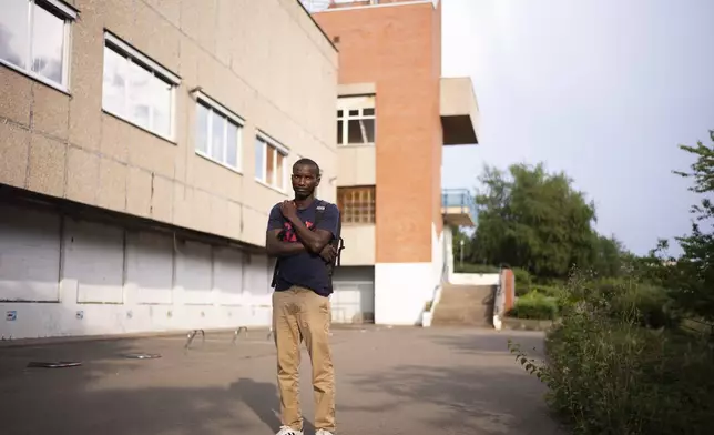 Omar Diallo, a 22-year-old migrant from Guinea in West Africa, poses for a portrait prior to an interview with The Associated Press near a dilapidated storage building were he and two friends being hunted and beaten up in 2020, in Erfurt, Germany, Wednesday, Aug. 14, 2024. (AP Photo/Markus Schreiber)