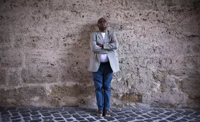 Daniel Egbe, a chemist from Cameroon who moved to Thuringia in 1994 to study, poses for a portrait after an interview with The Associated Press in Jena, Germany, Tuesday, Aug. 13, 2024. (AP Photo/Markus Schreiber)