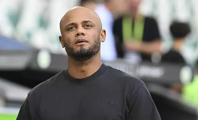 Bayern's head coach Vincent Kompany arrives at the stadium before the German Bundesliga soccer match between VfL Wolfsburg and FC Bayern Munich at the Volkswagen Arena in Wolfsburg, Germany, Sunday, Aug. 27, 2024. (Swen Pfoertner/dpa via AP)