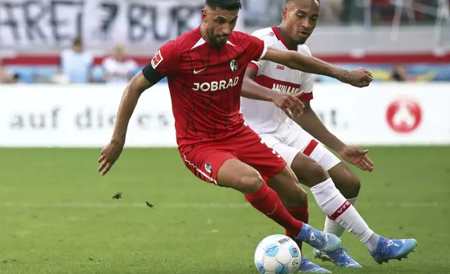 Freiburg's Vincenzo Grifo, left, and Stuttgart's Jamie Leweling in action during the Bundesliga soccer match between SC Freiburg and VfB Stuttgart at Europa-Park Stadium, Freiburg, Germany, Saturday Aug. 24, 2024. (Philipp von Ditfurth/dpa via AP)