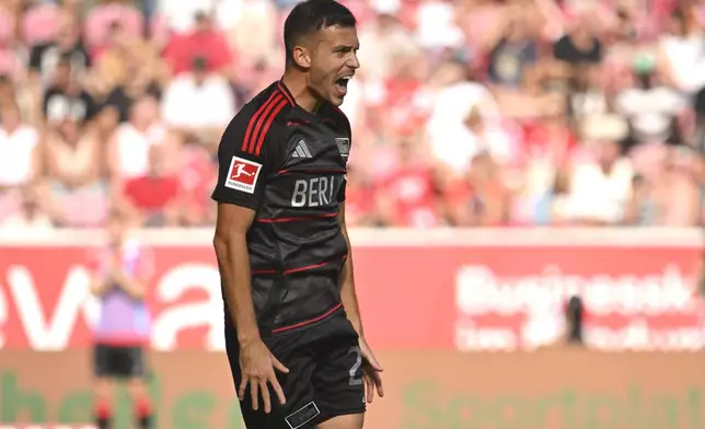 Union's Laszlo Benes celebrates scoring during the Bundesliga soccer match between FSV Mainz 05 and 1. FC Union Berlin, at Mewa Arena, Mainz, Germany, Saturday Aug. 24, 2024. (Torsten Silz/dpa via AP)