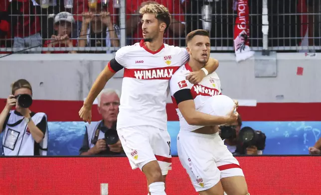 Stuttgart's Ermedin Demirovic, right, celebrates scoring with teammate Atakan Karazor during the Bundesliga soccer match between SC Freiburg and VfB Stuttgart at Europa-Park Stadium, Freiburg, Germany, Saturday Aug. 24, 2024. (Philipp von Ditfurth/dpa via AP)