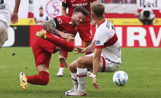 Stuttgart's Maximilian Mittelstädt, right, and Freiburg's Lukas Kubler in action during the Bundesliga soccer match between SC Freiburg and VfB Stuttgart at Europa-Park Stadium, Freiburg, Germany, Saturday Aug. 24, 2024. (Philipp von Ditfurth/dpa via AP)