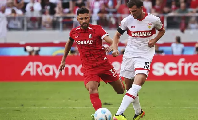 Freiburg's Vincenzo Grifo, left, and Stuttgart's Pascal Stenzel in action during the Bundesliga soccer match between SC Freiburg and VfB Stuttgart at Europa-Park Stadium, Freiburg, Germany, Saturday Aug. 24, 2024. (Philipp von Ditfurth/dpa via AP)