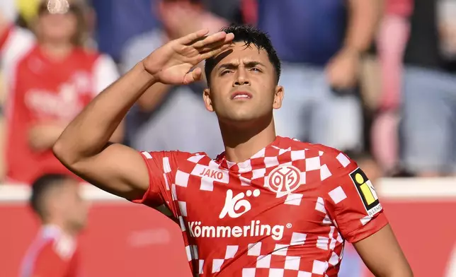 Mainz's Nadiem Amiri celebrates scoring during the Bundesliga soccer match between FSV Mainz 05 and 1. FC Union Berlin, at Mewa Arena, Mainz, Germany, Saturday Aug. 24, 2024. (Torsten Silz/dpa via AP)