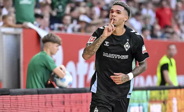 Bremen's Justin Njinmah celebrates scoring during the Bundesliga soccer match between FC Augsburg and Werder Bremen at WWK-Arena, Augsburg, Germany, Saturday Aug. 24, 2024. (Harry Langer/dpa via AP)