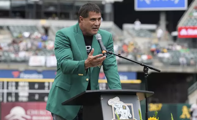 Former Oakland Athletics player Jose Canseco speaks after being inducted into the team's Hall of Fame before a baseball game against the San Francisco Giants, Saturday, Aug. 17, 2024, in Oakland, Calif. (AP Photo/Godofredo A. Vásquez)