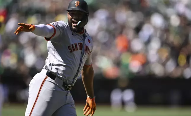 San Francisco Giants' Jerar Encarnacion celebrates after his two-run home run as he runs the bases against the Oakland Athletics during the tenth inning of a baseball game Sunday, Aug. 18, 2024, in Oakland, Calif. (AP Photo/Eakin Howard)