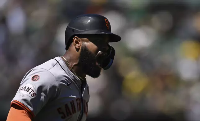 San Francisco Giants' Heliot Ramos celebrates as he runs the bases after hitting a solo home run against the Oakland Athletics during the seventh inning of a baseball game Sunday, Aug. 18, 2024, in Oakland, Calif. (AP Photo/Eakin Howard)