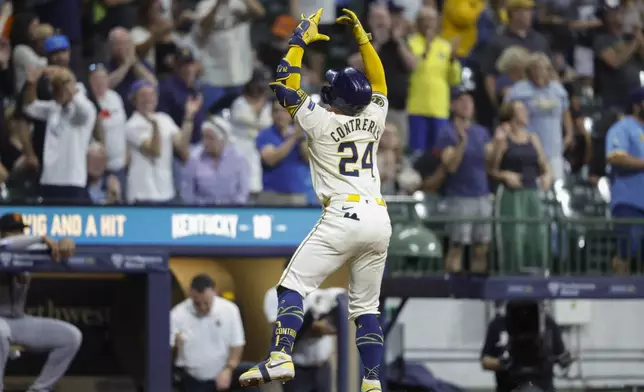 Milwaukee Brewers' William Contreras reacts after his two-run home run during the fifth inning of a baseball game against the San Francisco Giants, Wednesday, Aug. 28, 2024, in Milwaukee. (AP Photo/Jeffrey Phelps)