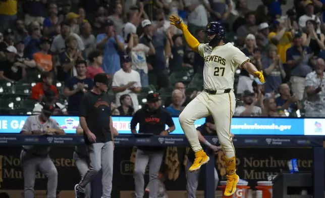 Milwaukee Brewers' Willy Adames reacts after hitting a two-run home run during the sixth inning of a baseball game against the San Francisco Giants Tuesday, Aug. 27, 2024, in Milwaukee. (AP Photo/Morry Gash)