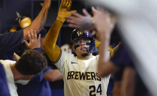 Milwaukee Brewers' William Contreras reacts after his two-run home run during the fifth inning of a baseball game against the San Francisco Giants, Wednesday, Aug. 28, 2024, in Milwaukee. (AP Photo/Jeffrey Phelps)