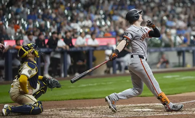 San Francisco Giants' Mike Yastrzemski hits a two-run home run during the seventh inning of a baseball game against the Milwaukee Brewers Tuesday, Aug. 27, 2024, in Milwaukee. (AP Photo/Morry Gash)