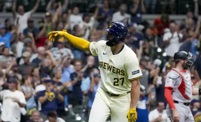 Milwaukee Brewers' Willy Adames reacts after hitting a two-run home run during the sixth inning of a baseball game against the San Francisco Giants Tuesday, Aug. 27, 2024, in Milwaukee. (AP Photo/Morry Gash)