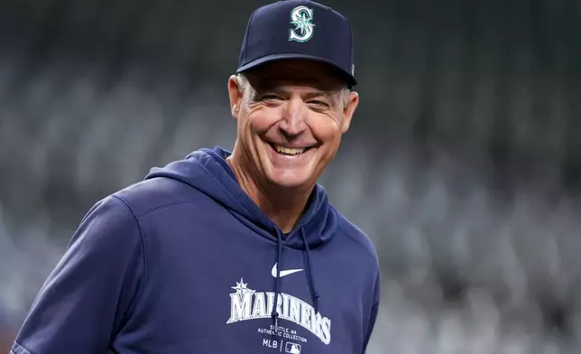 Seattle Mariners manager Dan Wilson smiles during batting practice before a baseball game against the San Francisco Giants, Friday, Aug. 23, 2024, in Seattle. (AP Photo/Lindsey Wasson)