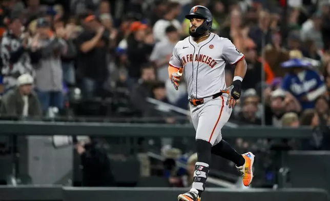 San Francisco Giants' Heliot Ramos jogs the bases after hitting a two-run home run against the Seattle Mariners during the sixth inning of a baseball game, Friday, Aug. 23, 2024, in Seattle. (AP Photo/Lindsey Wasson)