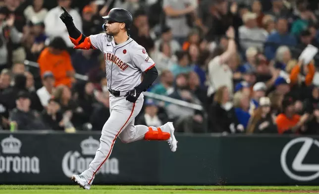 San Francisco Giants' Michael Conforto runs the bases after hitting a two-run home run to score Heliot Ramos against the Seattle Mariners during the fourth inning of a baseball game, Friday, Aug. 23, 2024, in Seattle. (AP Photo/Lindsey Wasson)