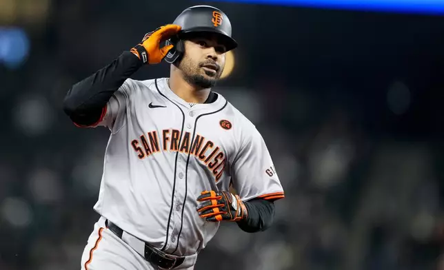 San Francisco Giants' LaMonte Wade Jr. rounds the bases after hitting a solo home run against the Seattle Mariners during the first inning of a baseball game, Friday, Aug. 23, 2024, in Seattle. (AP Photo/Lindsey Wasson)