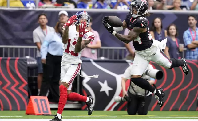 Houston Texans cornerback Derek Stingley Jr. (24) intercepts a pass intended for New York Giants wide receiver Jalin Hyatt (13) that was thrown by quarterback Daniel Jones (8) in the first half of a preseason NFL football game, Saturday, Aug. 17, 2024, in Houston. (AP Photo/Eric Christian Smith)