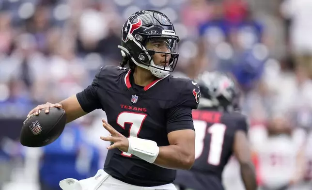 Houston Texans quarterback C.J. Stroud drops back to pass in the first half of a preseason NFL football game against the New York Giants, Saturday, Aug. 17, 2024, in Houston. (AP Photo/Eric Christian Smith)