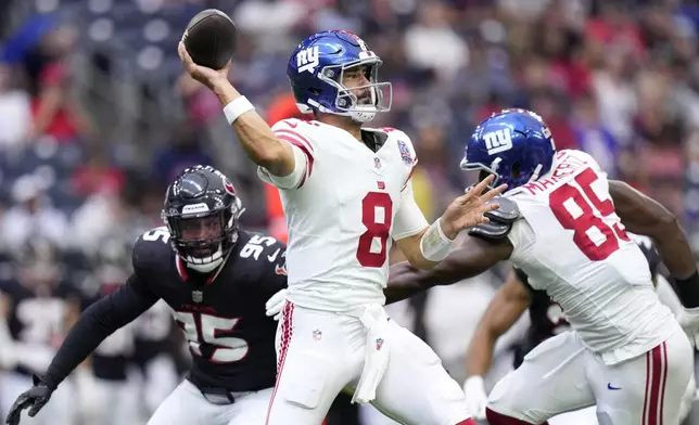 New York Giants quarterback Daniel Jones (8) throws a pass under pressure from Houston Texans defensive end Derek Barnett (95) in the first half of a preseason NFL football game, Saturday, Aug. 17, 2024, in Houston. (AP Photo/Eric Gay)