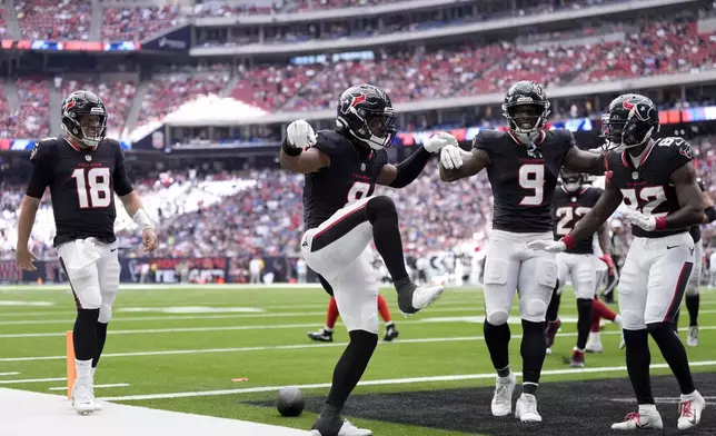 Houston Texans wide receiver John Metchie III, center, celebrates his touchdown catch thrown by quarterback Case Keenum (18) as Brevin Jordan (9) and Steven Sims (82) look on in the first half of a preseason NFL football game against the New York Giants, Saturday, Aug. 17, 2024, in Houston. (AP Photo/Eric Gay)