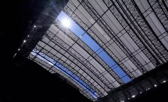 The sun shines thrown missing panels that were damaged by hurricane Beryl in the roof structure at NRG Stadium in the first half of a preseason NFL football game between the New York Giants and Houston Texans, Saturday, Aug. 17, 2024, in Houston. (AP Photo/Eric Gay)