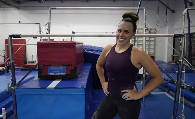 Angela Fuller, 44, poses as she trains at 5280 Gymnastics, Wednesday, July 24, 2024, in Littleton, Colo. (AP Photo/Brittany Peterson)