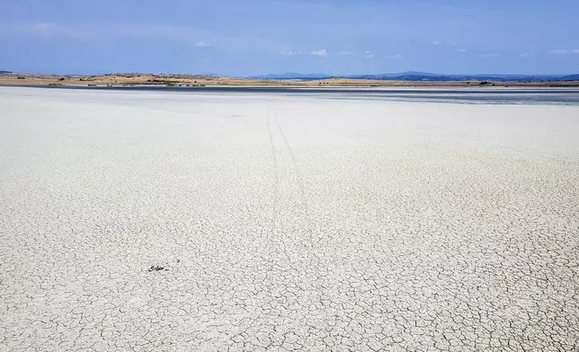 The dried out Lake Picrolimni is seen from above, in the village of Mikrokampos, northern Greece, Aug. 19, 2024. A severe drought in northern Greece, worsened by successive heatwaves and low rainfall, is causing water shortages that are threatening agriculture, drying up lakes, and stressing local communities dependent on tourism. (AP Photo/Giannis Papanikos)