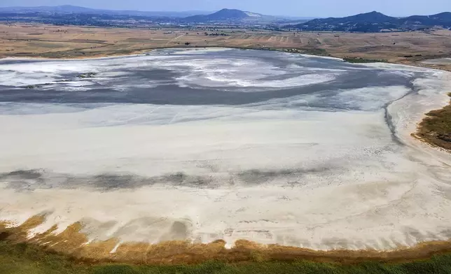 The dried out Lake Picrolimni is seen from above, near the village of Mikrokampos, northern Greece, Aug. 19, 2024. A severe drought in northern Greece, worsened by successive heatwaves and low rainfall, is causing water shortages that are threatening agriculture, drying up lakes, and stressing local communities dependent on tourism. (AP Photo/Giannis Papanikos)