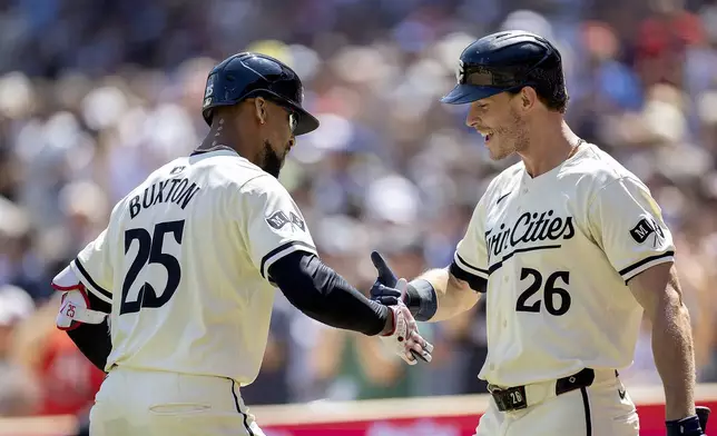 Minnesota Twins' Byron Buxton (25) celebrates his solo home run with Max Kepler (26) in the second inning of a baseball game against the Cleveland Guardians in Minneapolis, Minn., Sunday, Aug. 11, 2024. (Elizabeth Flores/Star Tribune via AP)