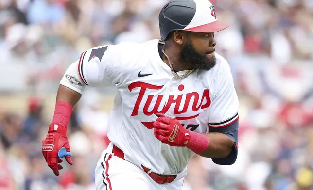 Minnesota Twins' Manuel Margot runs the bases after hitting a double against the Cleveland Guardians during the first inning of the first game of a baseball doubleheader, Friday, Aug. 9, 2024, in Minneapolis. (AP Photo/Matt Krohn)