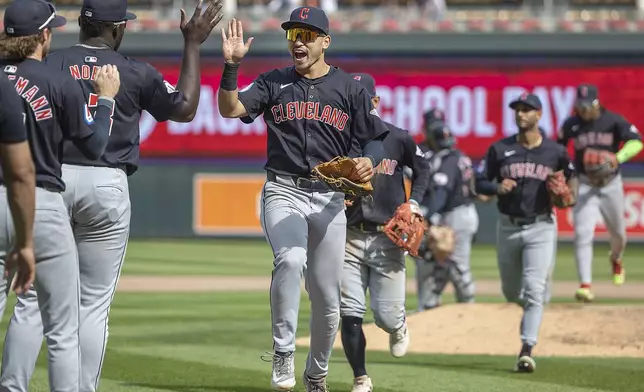 The Cleveland Guardians celebrate their 5-3 win over the Minnesota Twins in Minneapolis, Minn., Sunday, Aug. 11, 2024. (Elizabeth Flores/Star Tribune via AP)