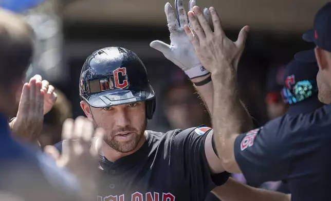 Cleveland Guardians' David Fry (6) celebrates in the dugout after nailing a solo home run in the top of the sixth inning of a baseball game against the Minnesota Twins in Minneapolis, Minn., Sunday, Aug. 11, 2024. (Elizabeth Flores/Star Tribune via AP)