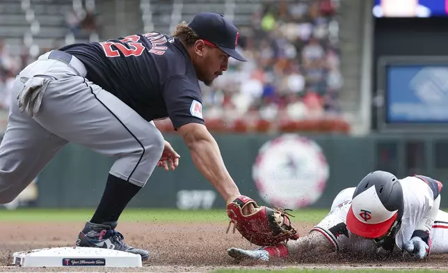 Cleveland Guardians first baseman Josh Naylor, left, tags out Minnesota Twins' Jose Miranda at first base during the first inning of the first game of a baseball doubleheader, Friday, Aug. 9, 2024, in Minneapolis. (AP Photo/Matt Krohn)