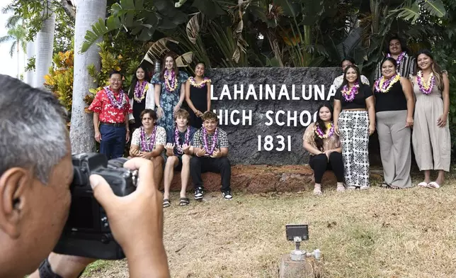 Lahainaluna High School 2024 graduates pose with Downtown Athletic Club of Hawaii President Keith Amemiya, left, after a scholarship presentation Wednesday, July 31, 2024, in Lahaina, Hawaii. (AP Photo/Matthew Thayer)