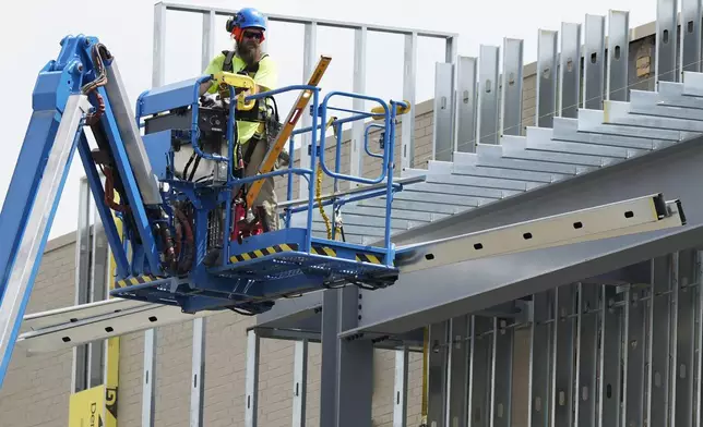 Construction worker works outside of commercial building site during a hot weather in Mount Prospect, Ill., Tuesday, Aug. 27, 2024. (AP Photo/Nam Y. Huh)