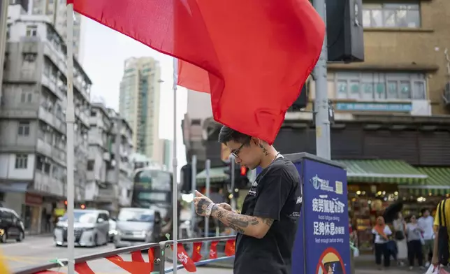 Joker Chan stands on the street of Hong Kong, on June 28, 2024. Chan, 30, was sentenced in 2022 for posts containing slogans like “Liberate Hong Kong, revolution of our times,” which were popularly chanted during massive anti-government protests in the city in 2019. Authorities said such slogans could imply separating Hong Kong from China, a red line for Beijing. (AP Photo/Billy H.C. Kwok)