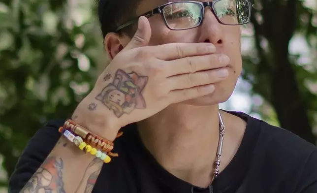 Joker Chan reacts during an interview, in Hong Kong, on June 28, 2024. Chan, 30, was sentenced in 2022 for posts containing slogans like “Liberate Hong Kong, revolution of our times,” which were popularly chanted during massive anti-government protests in the city in 2019. Authorities said such slogans could imply separating Hong Kong from China, a red line for Beijing. (AP Photo/Billy H.C. Kwok)