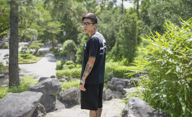 Joker Chan poses for photographs after an interview, in Hong Kong, on June 28, 2024. Chan, 30, was sentenced in 2022 for posts containing slogans like “Liberate Hong Kong, revolution of our times,” which were popularly chanted during massive anti-government protests in the city in 2019. Authorities said such slogans could imply separating Hong Kong from China — a red line for Beijing. (AP Photo/Billy H.C. Kwok)