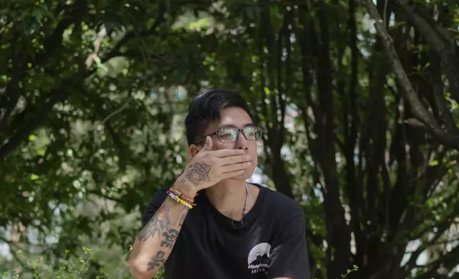 Joker Chan reacts during an interview, in Hong Kong, on June 28, 2024. After spending five months in jail for publishing seditious Instagram posts, Joker Chan returned to a harsh reality. Tattoos on his arms, legs and the sides of his neck, some related to anti-government protests, made his job search more difficult. (AP Photo/Billy H.C. Kwok)