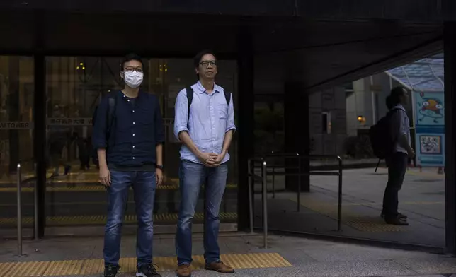 FILE - Former chief editor Chung Pui-kuen, right, and former acting editor Patrick Lam, left, of the now-defunct independent media outlet Stand News leave the court on the last day of the publication's sedition trial closing statements in Hong Kong, June 28, 2023. (AP Photo/Louise Delmotte, File)