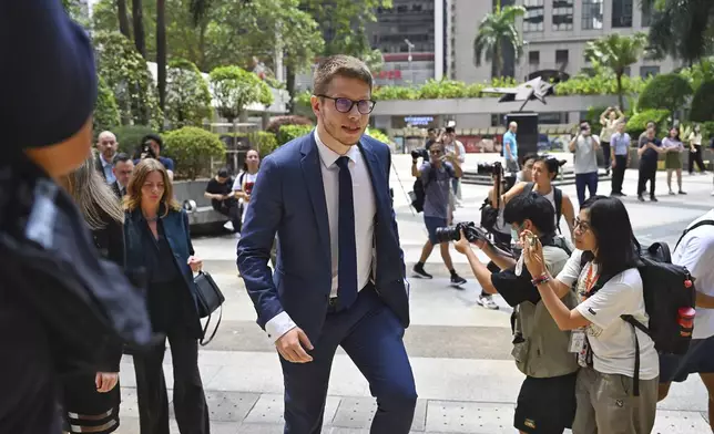 Foreign diplomats arrive at the district court ahead of the verdict on Chung Pui-kuen, the ex-chief editor of the now shuttered Stand News online outlet and his colleague Patrick Lam, former acting chief editor, in Hong Kong on Thursday, Aug. 29, 2024. (AP Photo/Billy H.C. Kwok)