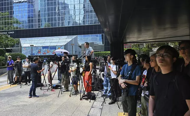 Member of the media wait outside the district court ahead of the verdict on Chung Pui-kuen, the ex-chief editor of the now shuttered Stand News online outlet and his colleague Patrick Lam, former acting chief editor, in Hong Kong on Thursday, Aug. 29, 2024. (AP Photo/Billy H.C. Kwok)