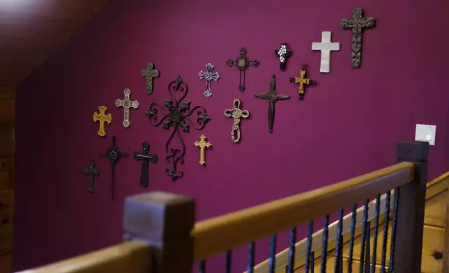 Crosses hang from one of the walls at the Rev. Ron Blakely’s home near Watertown, Tenn., on Friday, July 26, 2024. (AP Photo/Luis Andres Henao)