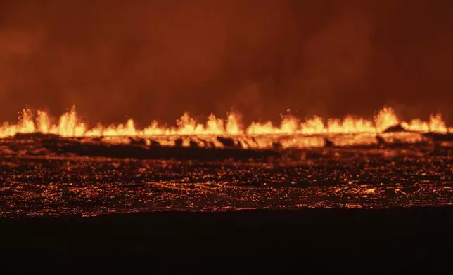 View of the lava fountains pouring out from the new eruptive fissure opened at Svartsengi volcanic system, Iceland, Thursday, Aug. 22, 2024, in a similar location as the previous eruptions. The fissure is 3 km north of Grindavik. (AP Photo/Marco di Marco)