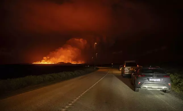 A new volcanic eruption is seen from the intersection between Reykjanesbraut, Iceland, and the road to Grindavik, Thursday, Aug. 22, 2024. (AP Photo/Marco di Marco)