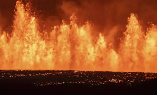 View of the lava fountains pouring out from the new eruptive fissure opened at Svartsengi volcanic system, Iceland, Thursday, Aug. 22, 2024, in a similar location as the previous eruptions. The fissure is 3 km north of Grindavik. (AP Photo/Marco di Marco)