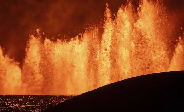 View of the lava fountains pouring out from the new eruptive fissure opened at Svartsengi volcanic system, Iceland, Thursday, Aug. 22, 2024, in a similar location as the previous eruptions. The fissure is 3 km north of Grindavik. (AP Photo/Marco di Marco)